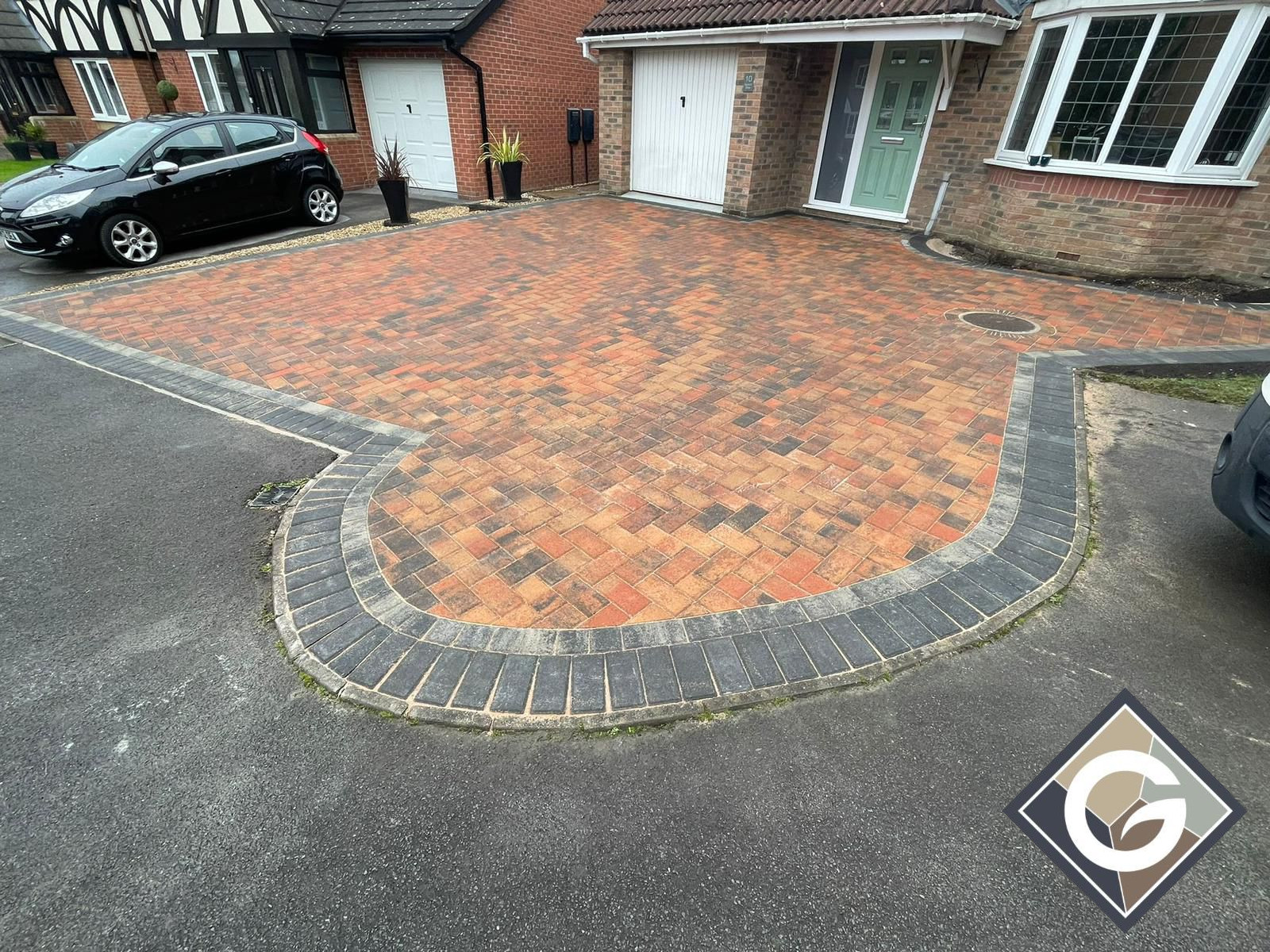 Herringbone brindle paved drive and car parking.